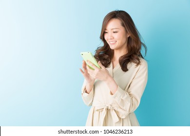 Young Attractive Asian Woman To See A Smart Phone