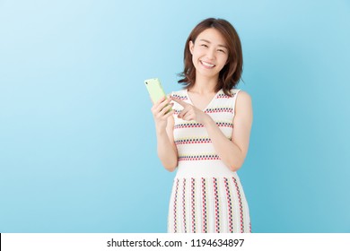 Young Attractive Asian Woman To See A Smart Phone