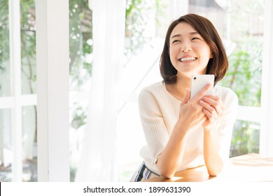 young attractive asian woman to see a smart phone, - Powered by Shutterstock