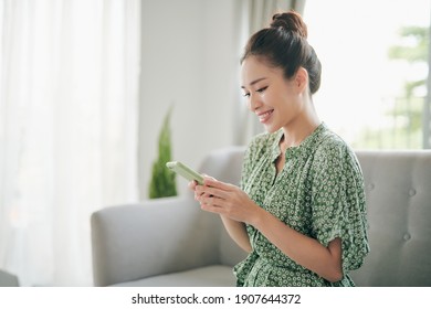 Young Attractive Asian Woman To See A Smart Phone