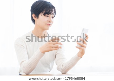 young attractive asian woman to see a smart phone