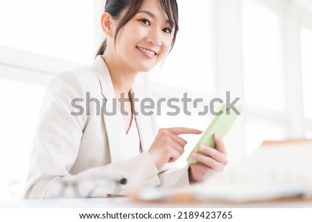 young attractive asian woman to see a smart phone, business