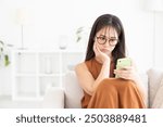 Young attractive Asian woman using a smartphone,trouble