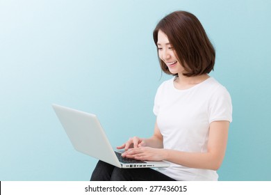 Young Attractive Asian Woman Using Laptop