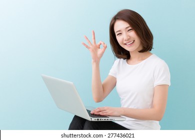 Young Attractive Asian Woman Using Laptop