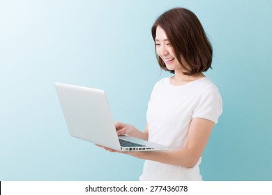 Young Attractive Asian Woman Using Laptop