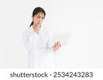 Young attractive asian woman in a white coat, laptop, trouble