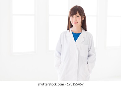 Young Attractive Asian Woman In A White Coat