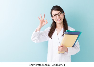 Young Attractive Asian Woman In A White Coat