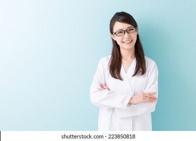 Young Attractive Asian Woman In A White Coat