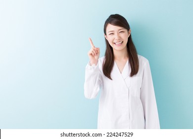 Young Attractive Asian Woman In A White Coat