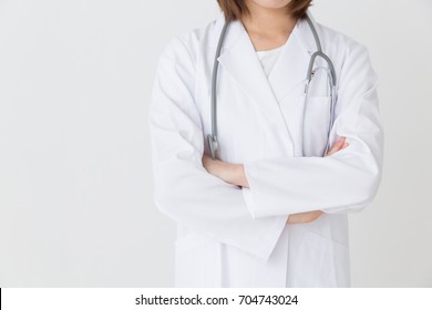 Young Attractive Asian Woman In A White Coat, No Face
