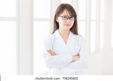 Young Attractive Asian Woman In A White Coat