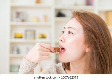 Young Attractive Asian Woman Who Eats A Serial Bar