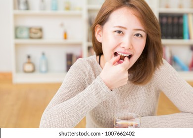 Young Attractive Asian Woman Who Eats A Serial Bar