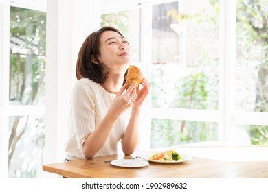 young attractive asian woman who eats - Shutterstock ID 1902989632