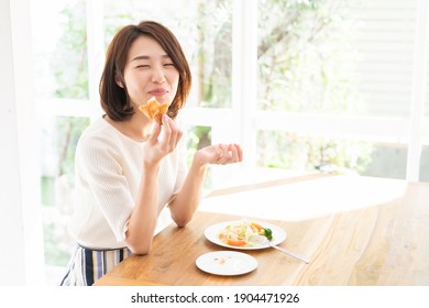 young attractive asian woman who eats - Shutterstock ID 1904471926