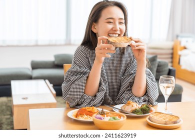 young attractive asian woman who eats - Powered by Shutterstock