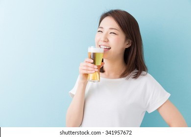 young attractive asian woman who drinks beer