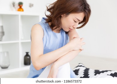 young attractive asian woman,itchy