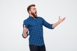 Young Attractive Bearded Man Singing Loud While Standing Isolated Over White Background