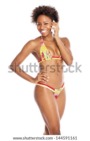young attractive black woman in bikini talking on cellphone
