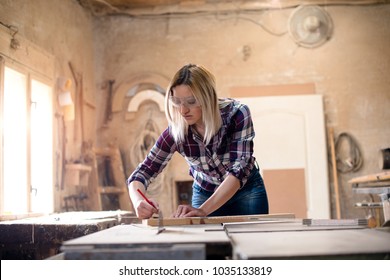 Young Attractive Blond Woman Is Working In Carpenter Workshop