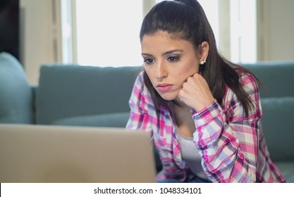 Young Attractive And Bored Latin Woman On Her 30s Working At Home Living Room Sitting On Couch With Laptop Computer In Stress Looking Sad And Tired In Freelance Entrepreneur Lifestyle Concept