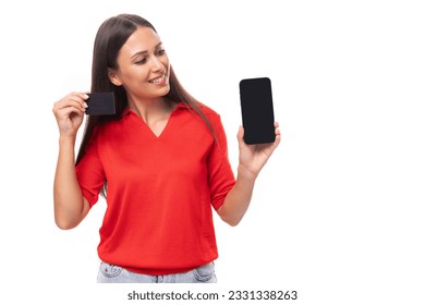 young attractive brunette woman in red stylish v-neck blouse holding smartphone with mockup