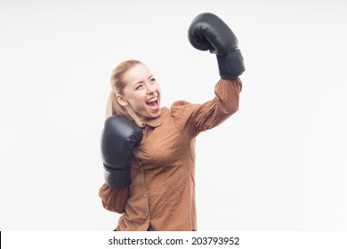 Young attractive business woman with boxing gloves celebrating win, isolated on white background
