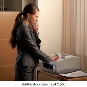 Young Attractive Business Woman Sending Fax