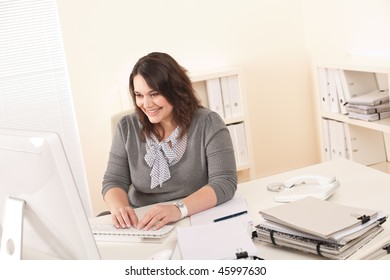 Young attractive business woman working at office with computer - Shutterstock ID 45997630