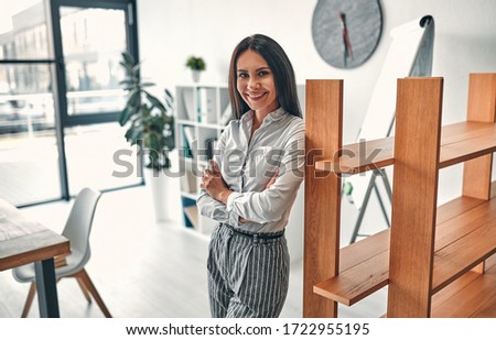 Young attractive business woman working in modern office.