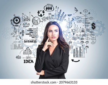 Young Attractive Businesswoman In Formal Suit Is Standing In Front Of Colourful Sketch With Brain, Goal, Bar And Pie Diagram In Background. Concept Of Imagination And Brainstorming For Creative Idea