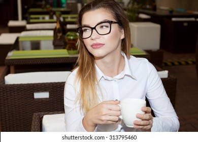 Young attractive businesswoman relaxing on a break, drinking tea. - Shutterstock ID 313795460