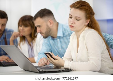 Young Attractive Businesswoman Using Her Smart Phone During Business Meeting With Colleagues At The Office Copyspace Communication Carrier Cell Mobility Distracting Distraction Concept