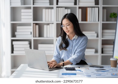 Young attractive businesswoman working on her project with laptop computer in modern office room. - Powered by Shutterstock