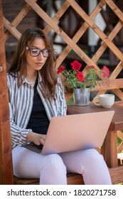 Young attractive businesswoman works remotely from home outdoors, smart confident woman surfing net, female freelancer using laptop. Summer, modern lifestyle concept, e-learning, digital, copy space - Shutterstock ID 1820271758