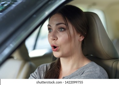 Young Attractive Caucasian Woman Behind The Wheel Driving A Car With Grimace Of Astonishment Or Shock, Mouth Opened. Strong Emotions, Wow Expression. Copy Space.