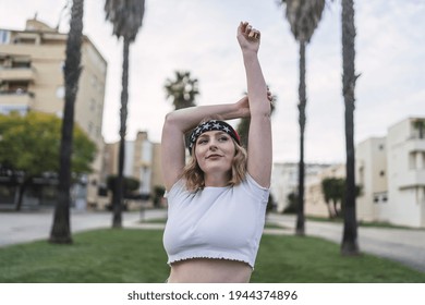 A Young Attractive Caucasian Woman With Blond Hair Wearing A Bandana With US Flag Print Outdoors