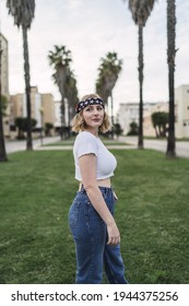 A Young Attractive Caucasian Woman With Blond Hair Wearing A Bandana With US Flag Print Outdoors