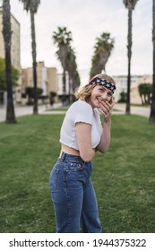 A Young Attractive Caucasian Woman With Blond Hair Wearing A Bandana With US Flag Print Outdoors