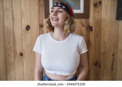 A Young Attractive Caucasian Woman With Short Blond Hair Wearing A Bandana With US Flag Print