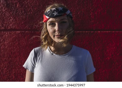 A Young Attractive Caucasian Woman With Short Blond Hair Wearing A Bandana With US Flag Print