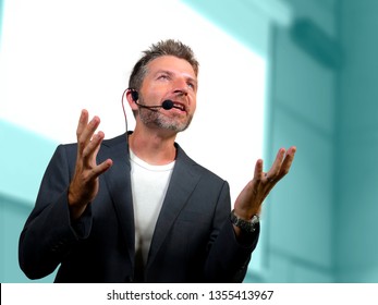 young attractive and confident successful man with headset speaking at corporate business coaching and training auditorium conference room talking giving motivation training from speaker stage - Shutterstock ID 1355413967