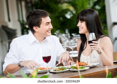 A Young And Attractive Couple Dining Together In An Outdoor Restaurant