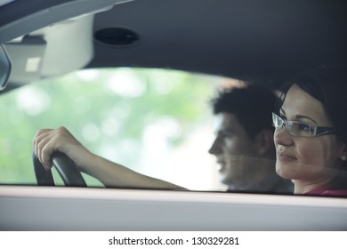 Young Attractive Couple Driving In A Car