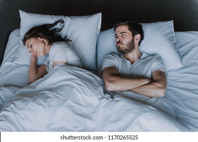 Young Attractive Couple Having Problem In Bed. Frustrated Man And Woman Not Talking Feeling Offended Or Stubborn. Concept Of Impotence. Man Have Problems.