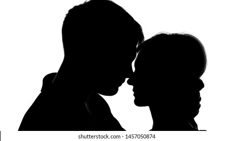 Young attractive couple silhouettes passionately kissing, strong feelings, love