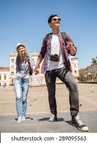 Young Attractive Couple Walking In Old European City.